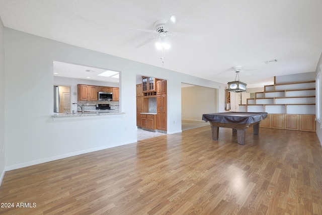 rec room with light hardwood / wood-style flooring, ceiling fan, and pool table