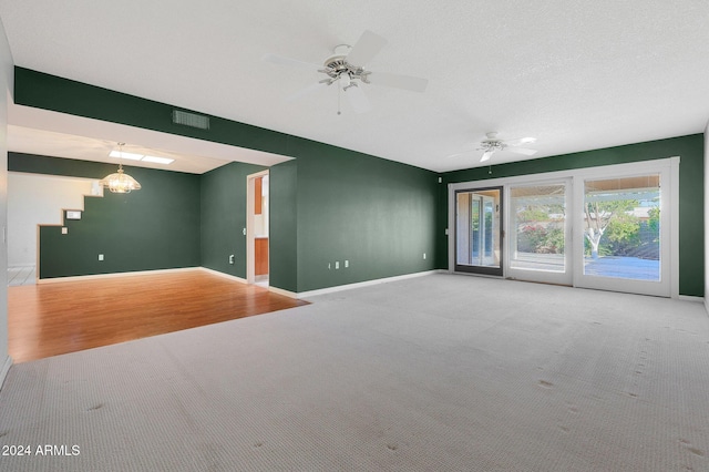 unfurnished living room with ceiling fan and carpet floors