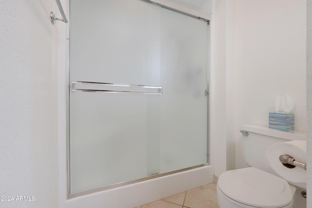 bathroom with tile patterned floors, toilet, and walk in shower