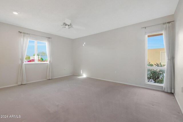 unfurnished room with light carpet and ceiling fan