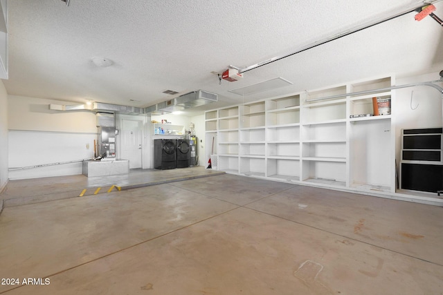 garage featuring washing machine and dryer, a garage door opener, and water heater