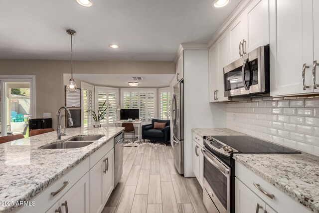 4316 E Janice Way, Phoenix, AZ 85032 - kitchen featuring appliances with stainless steel finishes, a sink, open floor plan, white cabinets, and tasteful backsplash