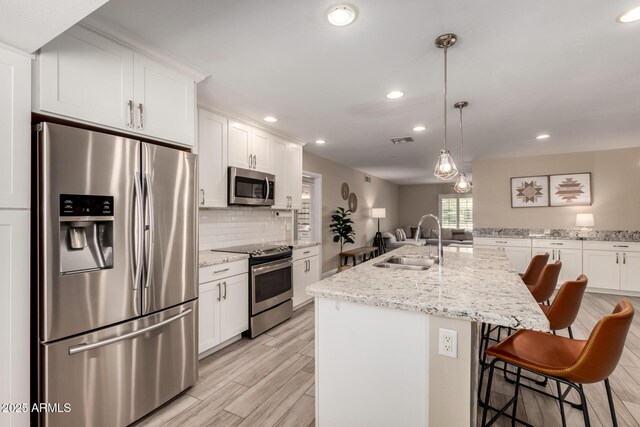 4316 E Janice Way, Phoenix, AZ 85032 - kitchen with appliances with stainless steel finishes, a sink, recessed lighting, tasteful backsplash, and white cabinetry