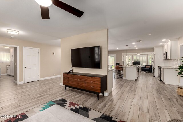 4316 E Janice Way, Phoenix, AZ 85032 - living area featuring light wood-style floors, a ceiling fan, baseboards, and recessed lighting