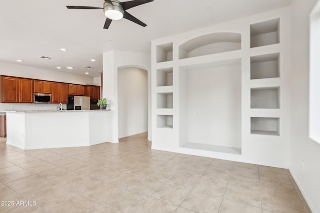 kitchen with visible vents, ceiling fan, built in features, light tile patterned floors, and appliances with stainless steel finishes