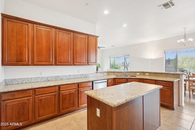 kitchen featuring visible vents, a sink, stainless steel dishwasher, a peninsula, and a chandelier