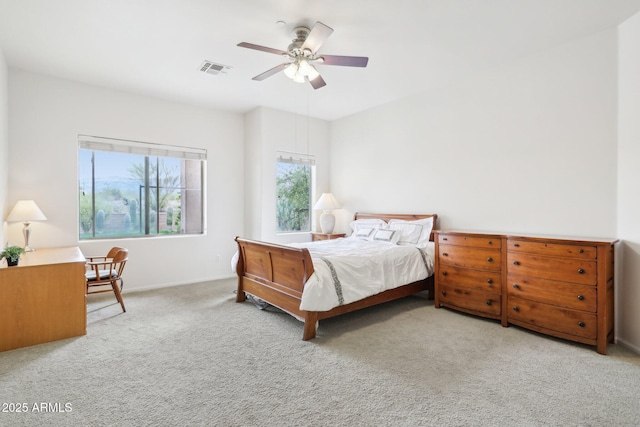 bedroom with visible vents, carpet flooring, baseboards, and ceiling fan