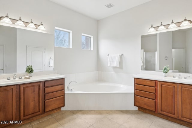 full bathroom featuring tile patterned floors, visible vents, two vanities, and a sink