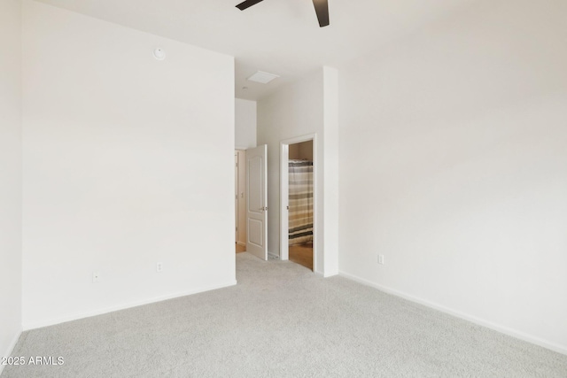 carpeted empty room with baseboards and ceiling fan