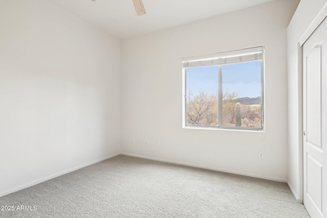 unfurnished room with a ceiling fan, carpet, baseboards, and a healthy amount of sunlight