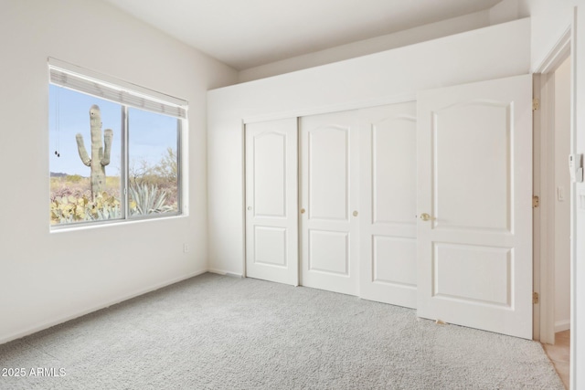 unfurnished bedroom with a closet and carpet