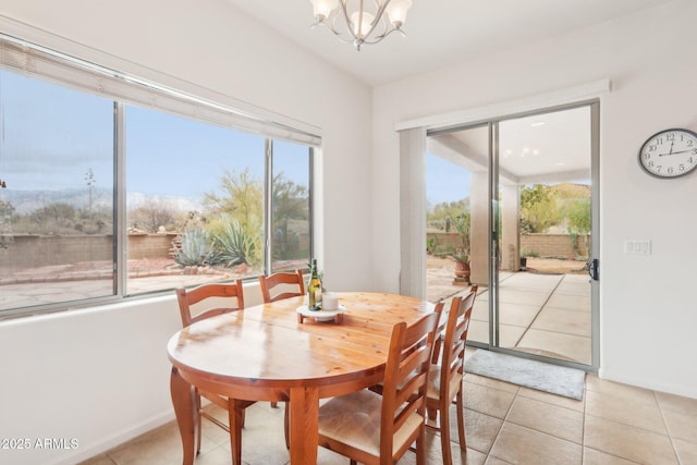 dining room with baseboards, plenty of natural light, an inviting chandelier, and light tile patterned flooring