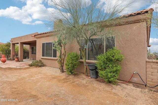 back of house featuring a patio area and stucco siding
