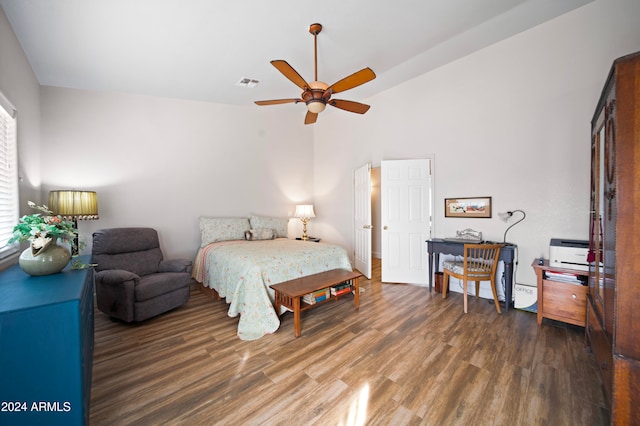 bedroom with ceiling fan, dark wood-type flooring, and lofted ceiling