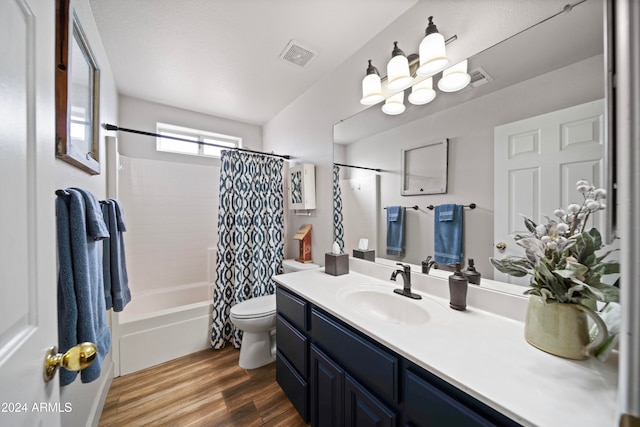 full bathroom with hardwood / wood-style floors, vanity, toilet, and shower / tub combo with curtain