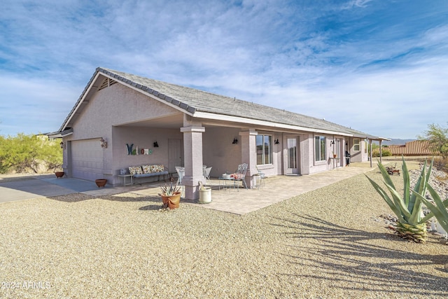 360 Bonita Dr, Wickenburg, AZ 85390 - rear view of property featuring stucco siding, driveway, and a garage