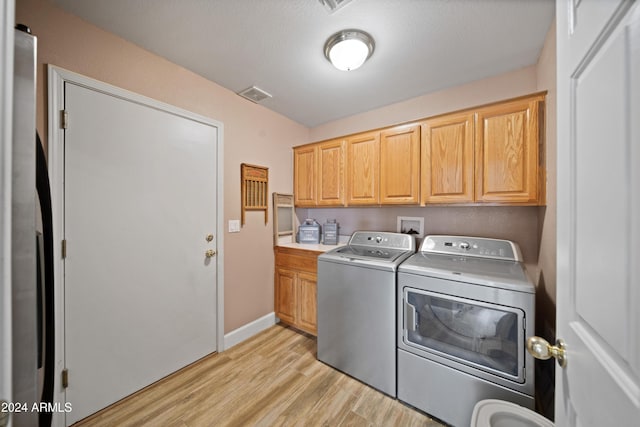 360 Bonita Dr, Wickenburg, AZ 85390 - laundry area featuring cabinet space, washing machine and dryer, and light wood-style floors