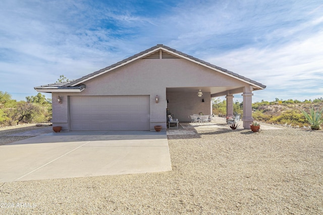 360 Bonita Dr, Wickenburg, AZ 85390 - view of front of house featuring an attached garage, driveway, and stucco siding