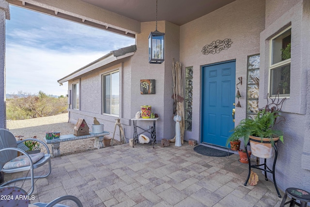 360 Bonita Dr, Wickenburg, AZ 85390 - view of exterior entry with stucco siding and a patio