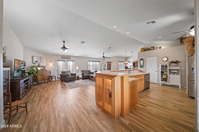 360 Bonita Dr, Wickenburg, AZ 85390 - kitchen featuring a ceiling fan, appliances with stainless steel finishes, vaulted ceiling, wood finished floors, and open floor plan