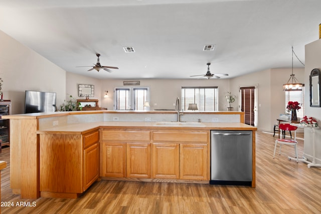 kitchen featuring a center island with sink, dishwasher, light hardwood / wood-style floors, and sink