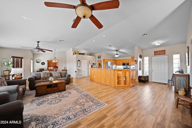 living room with light hardwood / wood-style flooring and lofted ceiling