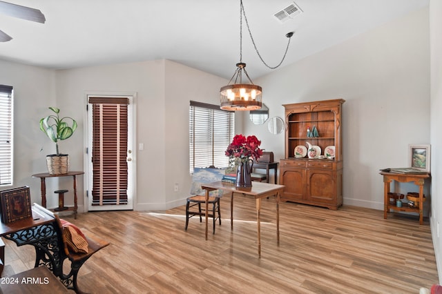 dining space featuring ceiling fan with notable chandelier and light wood-type flooring