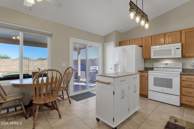 kitchen featuring white appliances, light tile patterned floors, lofted ceiling, and hanging light fixtures