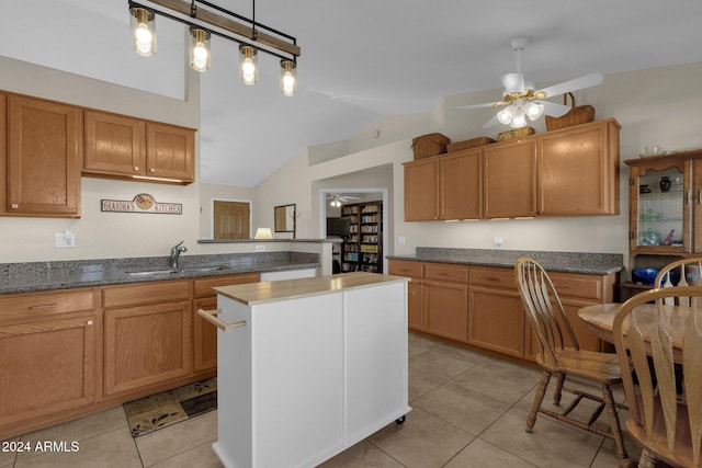 kitchen with a kitchen island, decorative light fixtures, sink, light tile patterned flooring, and ceiling fan