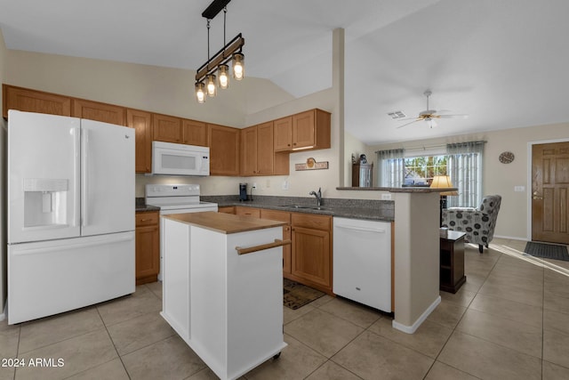 kitchen with light tile patterned floors, white appliances, lofted ceiling, ceiling fan with notable chandelier, and sink