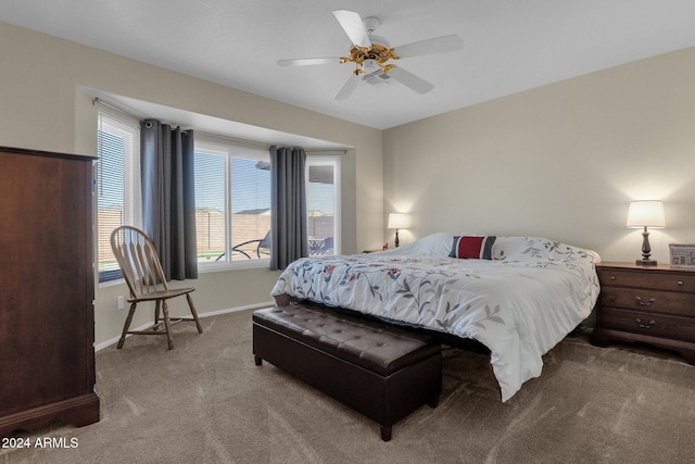 carpeted bedroom featuring ceiling fan and multiple windows