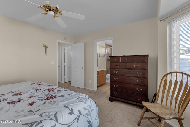 carpeted bedroom with ceiling fan and ensuite bath