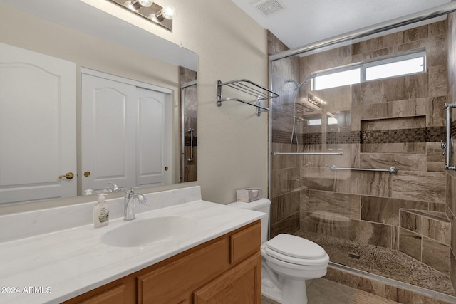 bathroom featuring toilet, walk in shower, and vanity