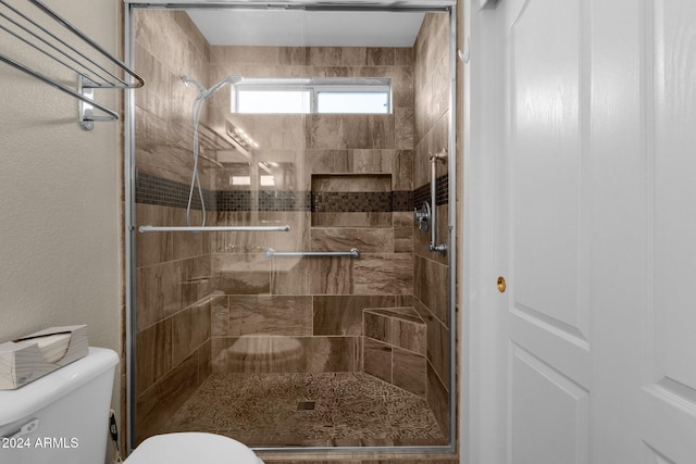 bathroom with toilet and walk in shower