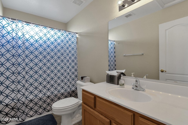 bathroom with toilet, vanity, and walk in shower