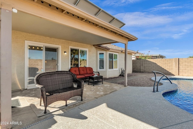 view of patio / terrace featuring a fenced in pool, an outdoor living space, and pool water feature