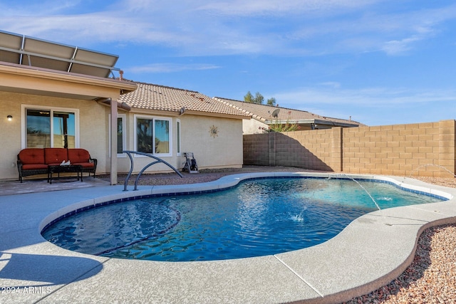 view of swimming pool with pool water feature and a patio area