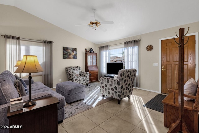 tiled living room with ceiling fan and vaulted ceiling