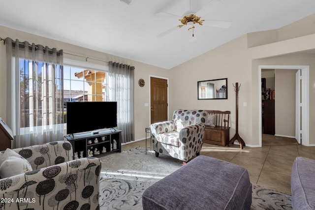 living room with ceiling fan, vaulted ceiling, and light tile patterned flooring