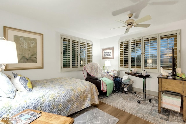 bedroom with wood finished floors and a ceiling fan