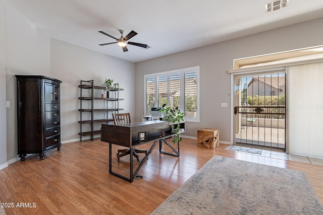 office area with a wealth of natural light, ceiling fan, and hardwood / wood-style flooring