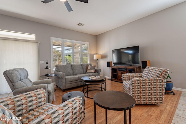 living room with ceiling fan and light hardwood / wood-style floors