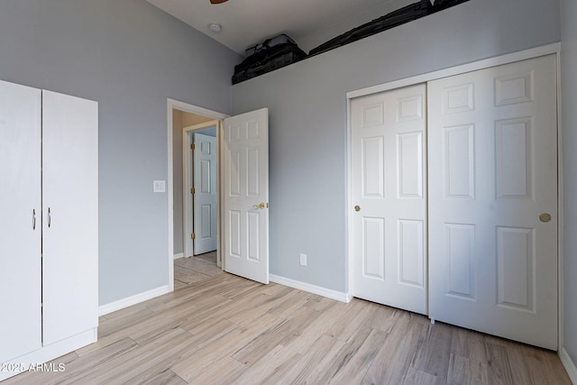 unfurnished bedroom with light hardwood / wood-style floors and a closet