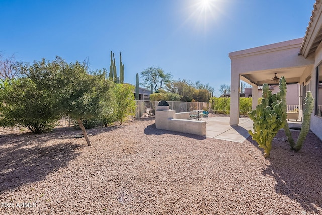 view of yard featuring a patio area and ceiling fan