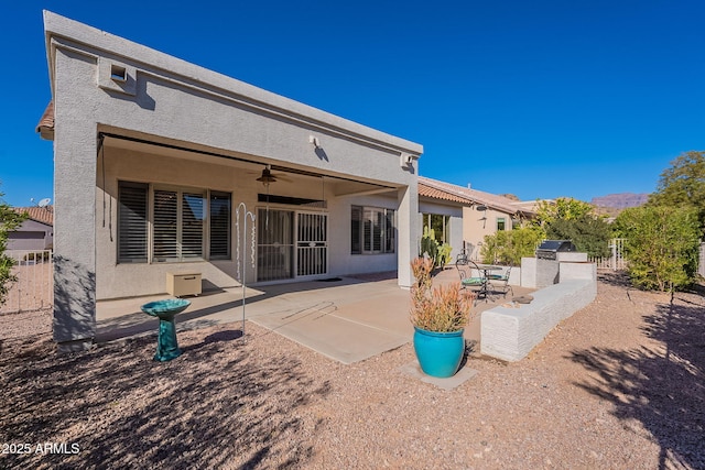 back of property with ceiling fan, area for grilling, and a patio