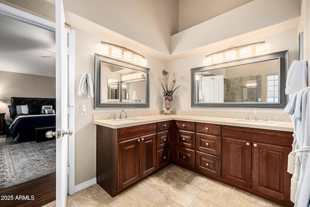 ensuite bathroom featuring connected bathroom, a sink, and double vanity