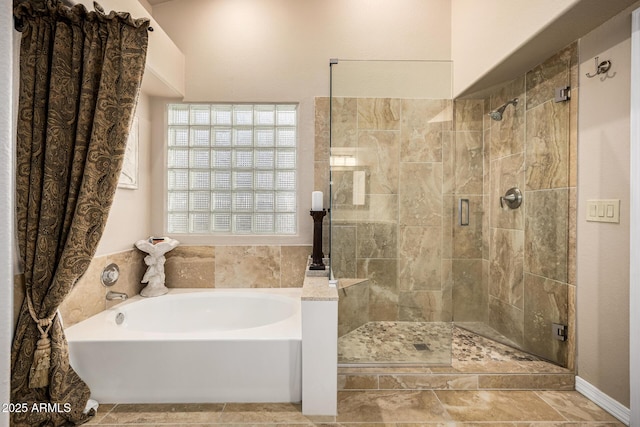 full bathroom featuring a stall shower and a garden tub