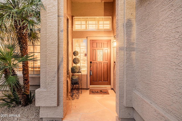 property entrance featuring stucco siding