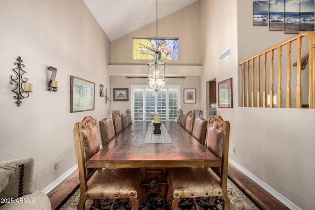 dining area with a chandelier, wood finished floors, visible vents, and baseboards