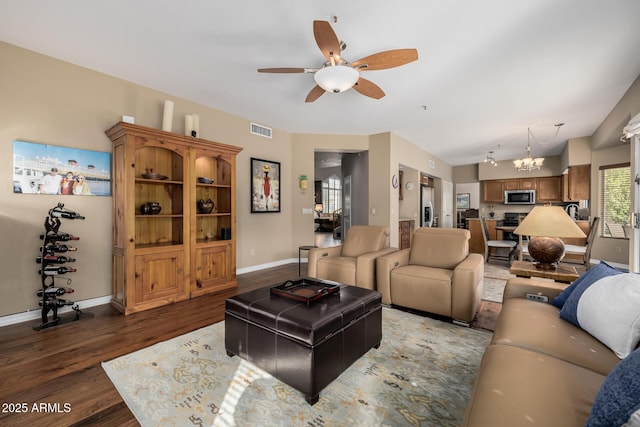 living room with baseboards, visible vents, wood finished floors, and ceiling fan with notable chandelier